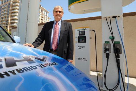 man at a hybrid gas pump