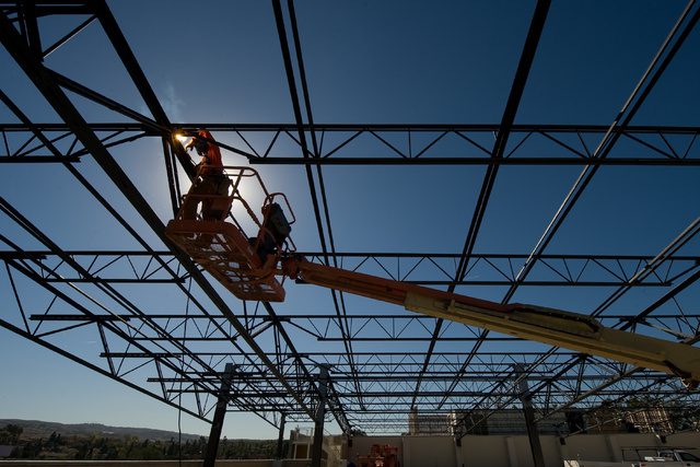 construction worker building solar panels