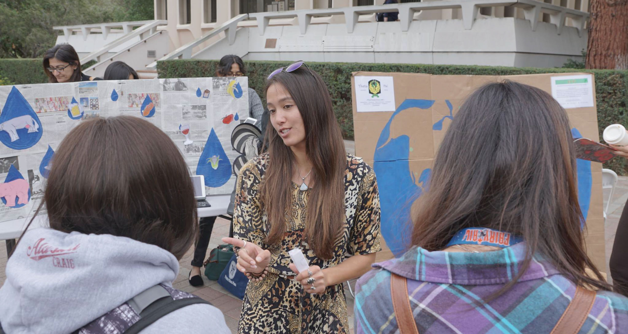 student talking to students on campus about climate change