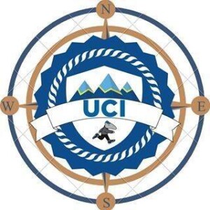 circular logo in shape of a ship wheel, mountains in the middle, anteater running, UCI