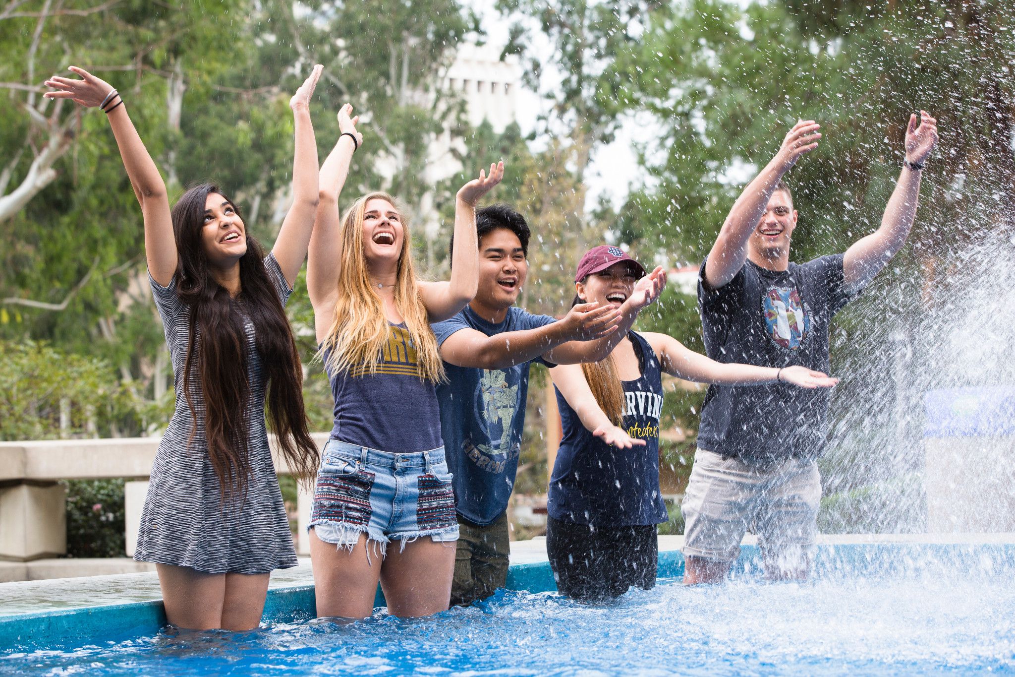 group of students playing in a fountain