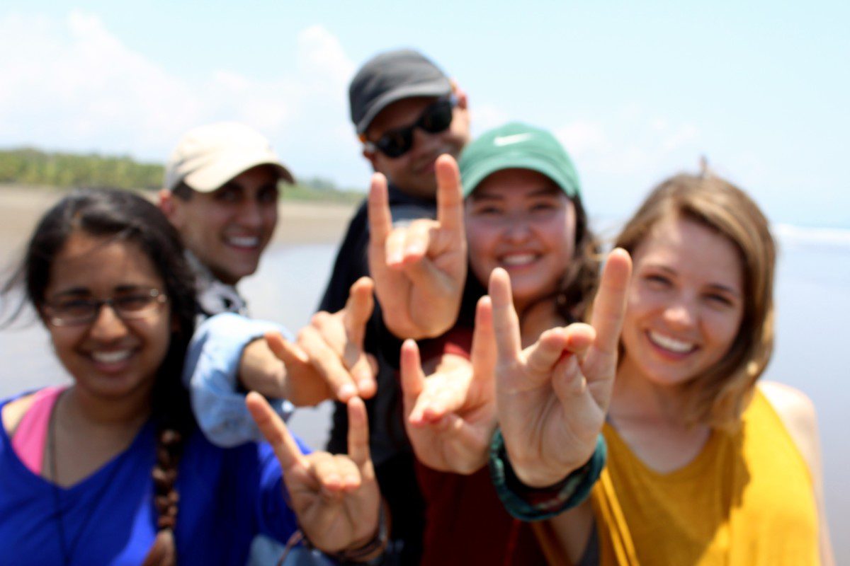 UC Irvine students performing the zot hand salute